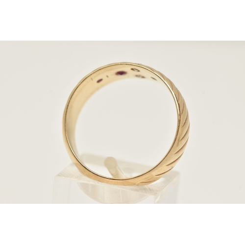 401 - A YELLOW METAL BAND RING, a yellow metal slightly tapered band ring with etched detail, flush set wi... 