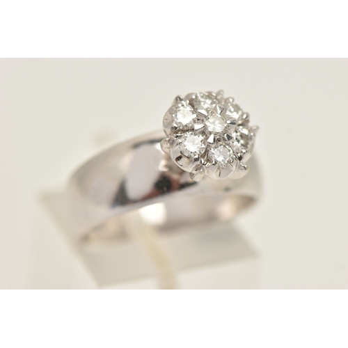 402 - A DIAMOND CLUSTER RING, seven round brilliant cut diamonds, prong set in white metal, approximate to... 