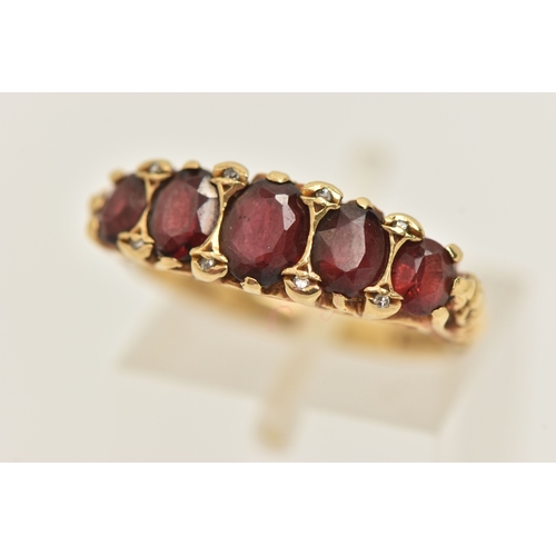 412 - AN 18CT GOLD GARNET AND DIAMOND RING, set with five oval cut graduated garnets, with small single cu... 