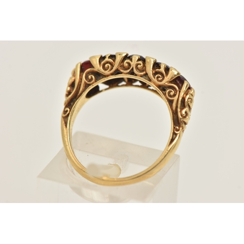 412 - AN 18CT GOLD GARNET AND DIAMOND RING, set with five oval cut graduated garnets, with small single cu... 