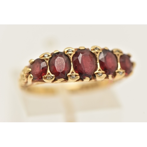 412 - AN 18CT GOLD GARNET AND DIAMOND RING, set with five oval cut graduated garnets, with small single cu... 