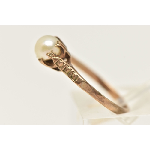 414 - A 9CT GOLD CULTURED PEARL RING, a single cream pearl measuring approximately 6mm, sitting slanted in... 