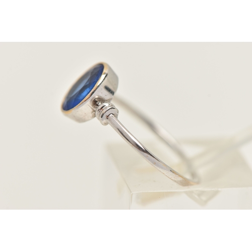419 - A WHITE METAL GARNET TOPPED DOUBLET RING, designed as an oval cut blue paste with garnet top, milgra... 