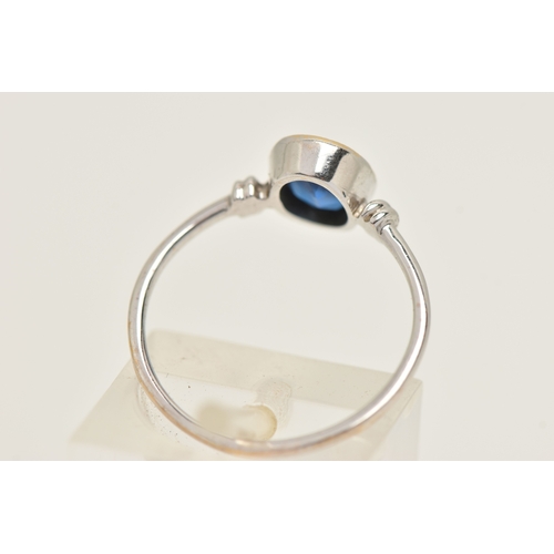 419 - A WHITE METAL GARNET TOPPED DOUBLET RING, designed as an oval cut blue paste with garnet top, milgra... 