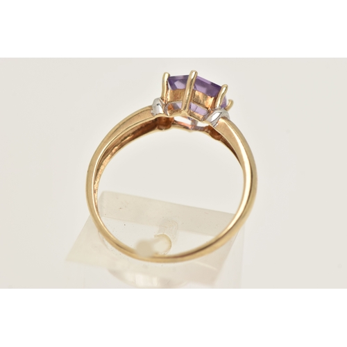 420 - A 9CT GOLD AMETHYST RING, set with a fancy cut amethyst, claw set to the polished band, hallmarked 9... 