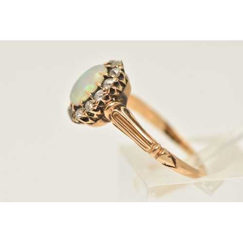421 - A YELLOW METAL OPAL AND DIAMOND CLUSTER RING, of an oval form, set with a central oval cut white opa... 