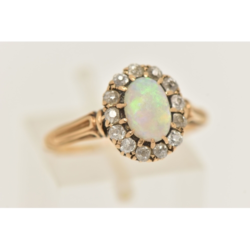 421 - A YELLOW METAL OPAL AND DIAMOND CLUSTER RING, of an oval form, set with a central oval cut white opa... 