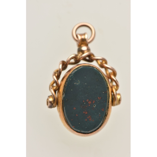 424 - A YELLOW METAL SWIVEL FOB, of an oval form set with an intaglio bloodstone inlay and polished bloods... 