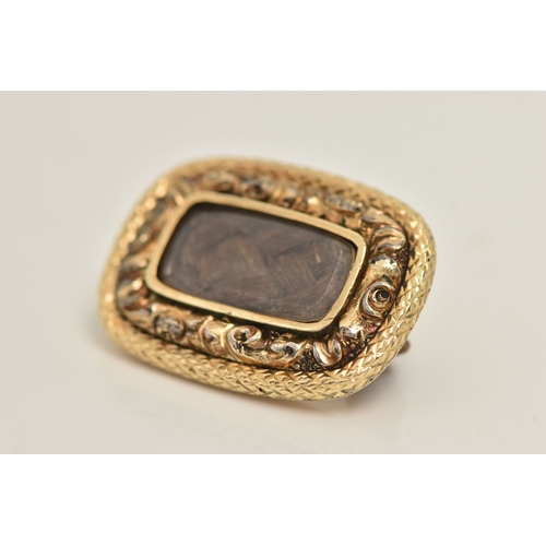 427 - A YELLOW METAL HAIR WORK MEMORIAL BROOCH, of a rounded rectangular form with a central brown woven h... 