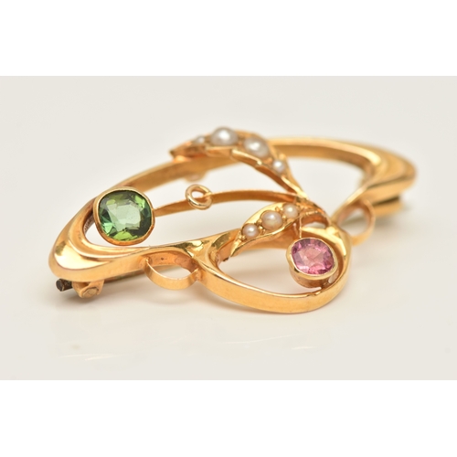 428 - A CASED YELLOW METAL GEM SET BROOCH, of an open work design, set with a pink and a green tourmaline ... 