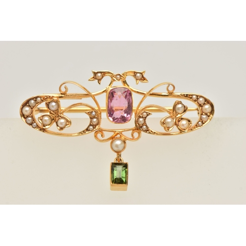 429 - A CASED YELLOW METAL GEM SET BROOCH, open work design set with a central pink tourmaline, split pear... 
