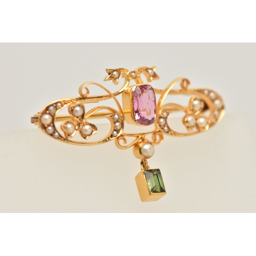 429 - A CASED YELLOW METAL GEM SET BROOCH, open work design set with a central pink tourmaline, split pear... 