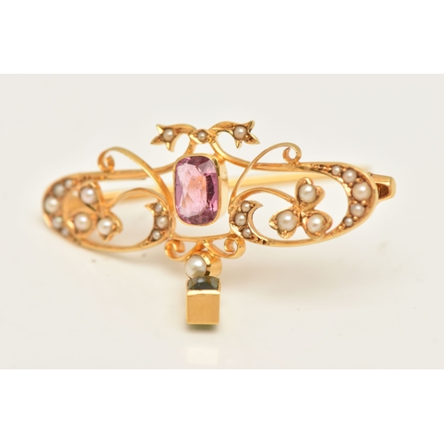429 - A CASED YELLOW METAL GEM SET BROOCH, open work design set with a central pink tourmaline, split pear... 