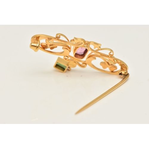 429 - A CASED YELLOW METAL GEM SET BROOCH, open work design set with a central pink tourmaline, split pear... 