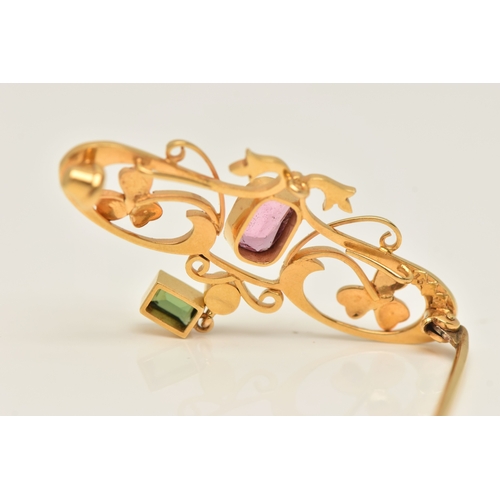 429 - A CASED YELLOW METAL GEM SET BROOCH, open work design set with a central pink tourmaline, split pear... 