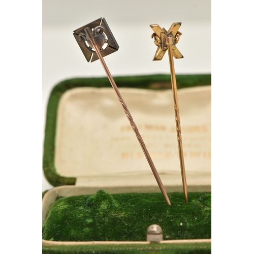 430 - TWO STICK PINS, the first a yellow metal stick pin with cross and crown detail, set with hard stone,... 