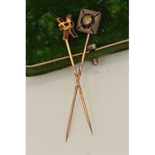 430 - TWO STICK PINS, the first a yellow metal stick pin with cross and crown detail, set with hard stone,... 