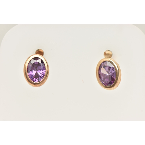 433 - A PAIR OF AMETHYST SET STUD EARRINGS, each earring of an oval form, set with an oval cut amethyst to... 