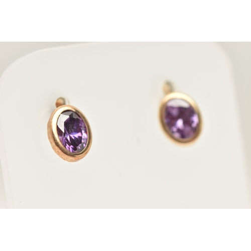 433 - A PAIR OF AMETHYST SET STUD EARRINGS, each earring of an oval form, set with an oval cut amethyst to... 