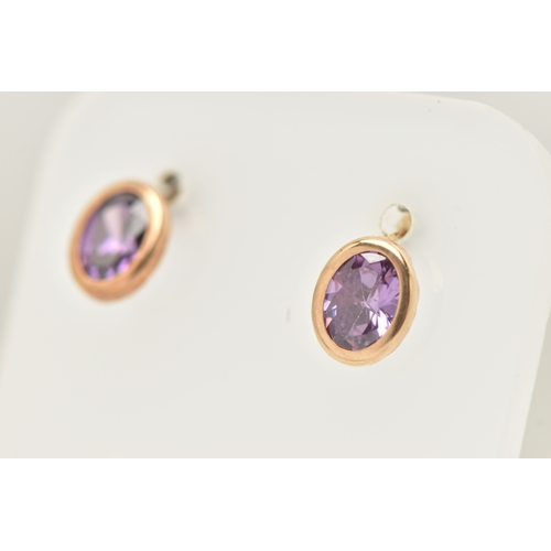 433 - A PAIR OF AMETHYST SET STUD EARRINGS, each earring of an oval form, set with an oval cut amethyst to... 
