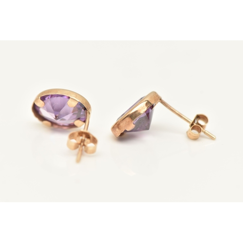433 - A PAIR OF AMETHYST SET STUD EARRINGS, each earring of an oval form, set with an oval cut amethyst to... 