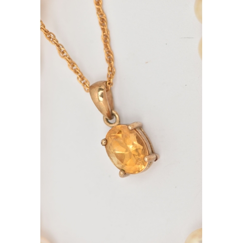 449 - TWO NECKLACES, the first an oval cut Citrine pendant in a yellow metal mount with tapered bail, unma... 