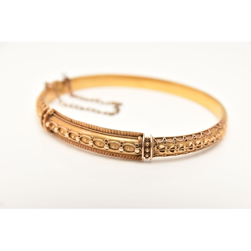 453 - A LATE VICTORIAN 15CT GOLD HINGED BANGLE, Etruscan design with applied bead work, fitted with a push... 
