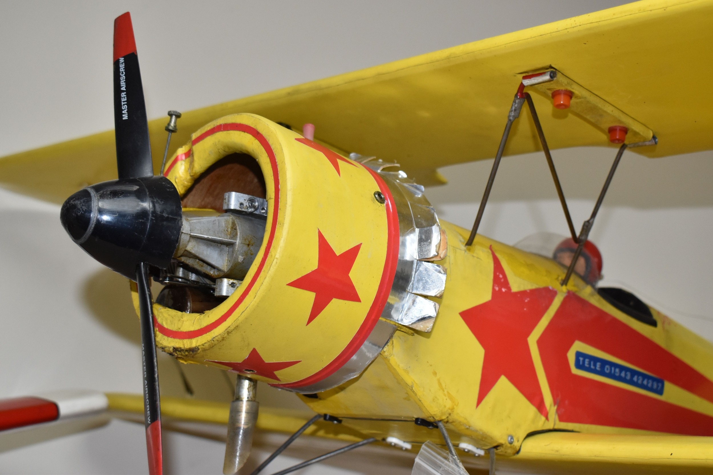 A REMOTE CONTROLLED AEROPLANE, featuring a biplane model aircraft ...