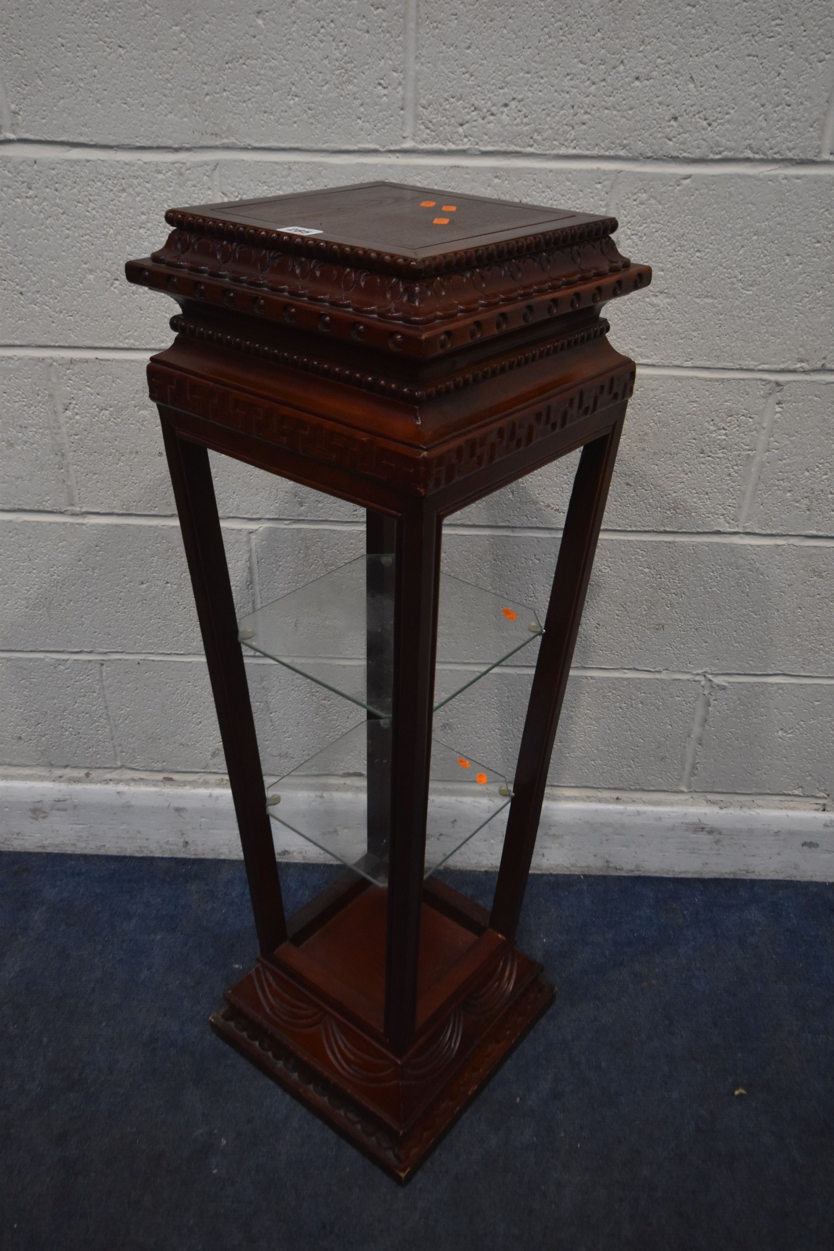 A HARDWOOD PYRAMID OPEN DISPLAY STAND, with two glass shelves, 33cm x ...