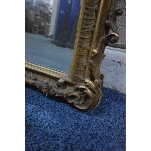 266 - A 19TH CENTURY GILT WOOD AND RESIN BEVELLED EDGE OVER-MANTEL MIRROR, with scrolled and foliate desig... 