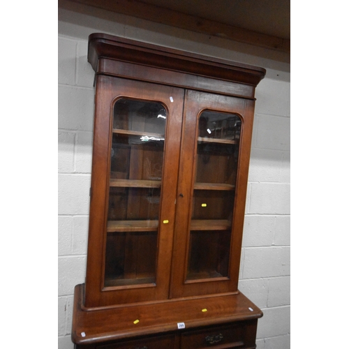 269 - A 19TH CENTURY MAHOGANY BOOKCASE, the double glazed doors enclosing three shelves, atop a base with ... 