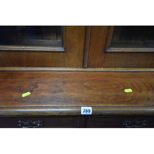 269 - A 19TH CENTURY MAHOGANY BOOKCASE, the double glazed doors enclosing three shelves, atop a base with ... 
