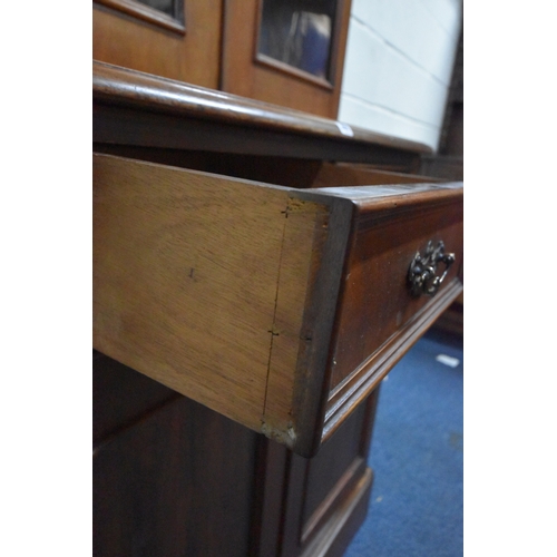 269 - A 19TH CENTURY MAHOGANY BOOKCASE, the double glazed doors enclosing three shelves, atop a base with ... 