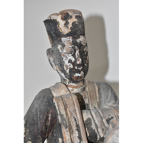 792 - A GROUP OF THREE CHINESE QING DYNASTY CARVED ANCESTRAL VOTIVE FIGURES comprising a figure riding a h... 