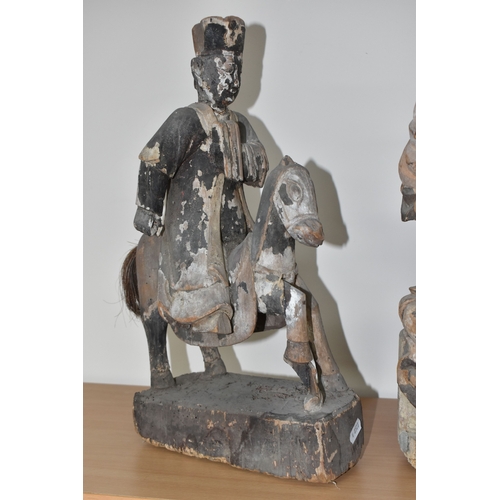 792 - A GROUP OF THREE CHINESE QING DYNASTY CARVED ANCESTRAL VOTIVE FIGURES comprising a figure riding a h... 