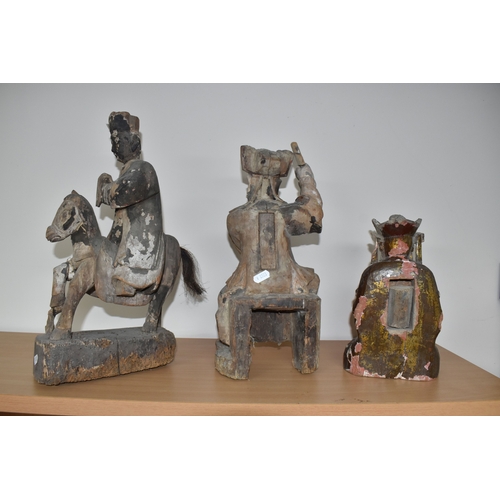 792 - A GROUP OF THREE CHINESE QING DYNASTY CARVED ANCESTRAL VOTIVE FIGURES comprising a figure riding a h... 