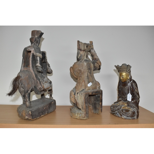 792 - A GROUP OF THREE CHINESE QING DYNASTY CARVED ANCESTRAL VOTIVE FIGURES comprising a figure riding a h... 