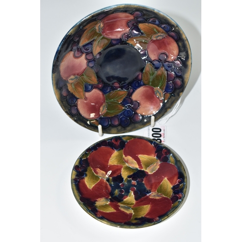 800 - TWO PIECES OF MOORCROFT POTTERY, a saucer featuring tube lined pomegranate pattern, diameter 13.5cm,... 