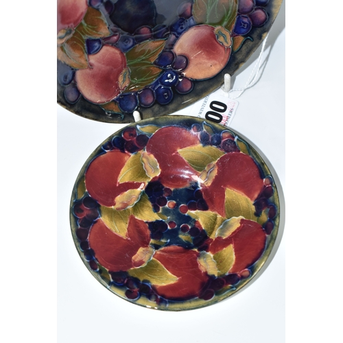 800 - TWO PIECES OF MOORCROFT POTTERY, a saucer featuring tube lined pomegranate pattern, diameter 13.5cm,... 