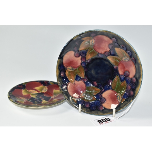 800 - TWO PIECES OF MOORCROFT POTTERY, a saucer featuring tube lined pomegranate pattern, diameter 13.5cm,... 