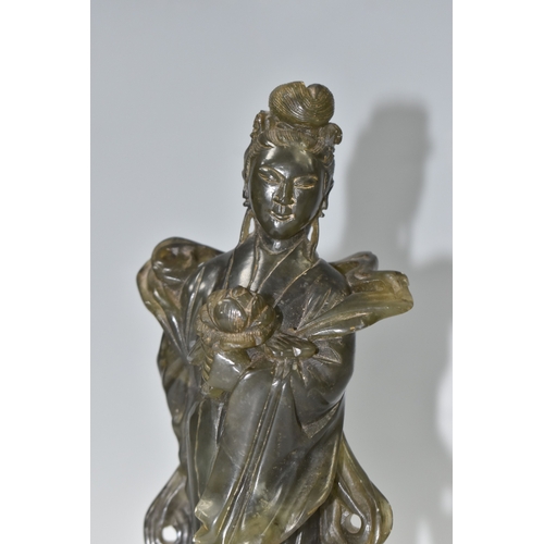 812 - TWO CHINESE CARVED NEPHRITE FIGURES possibly depicting He Xiangu comprising a sculpture of the figur... 