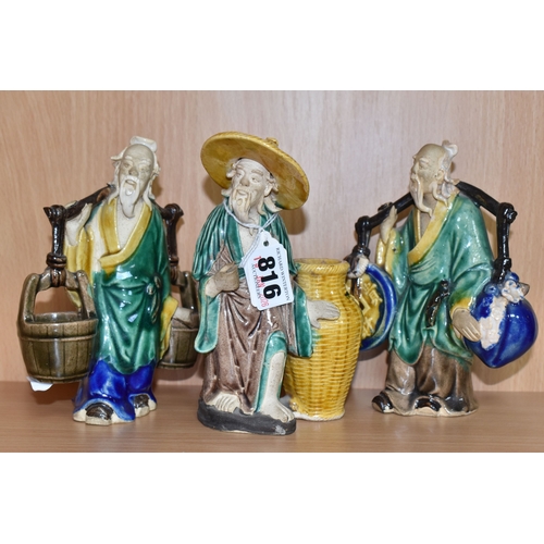 816 - A GROUP OF THREE CHINESE EXPORT MUD MEN FIGURES comprising two different figures carrying items with... 