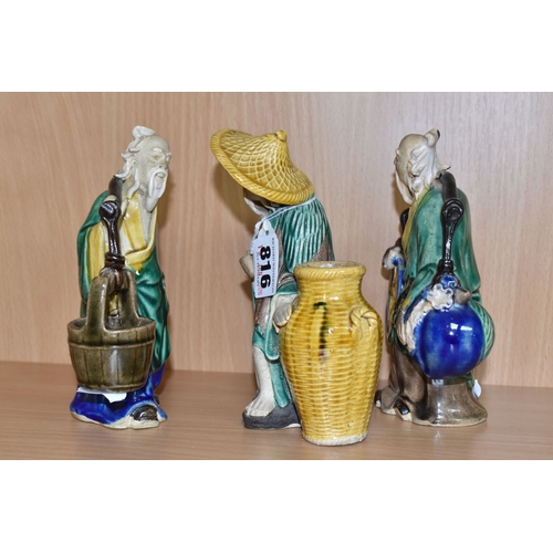 816 - A GROUP OF THREE CHINESE EXPORT MUD MEN FIGURES comprising two different figures carrying items with... 