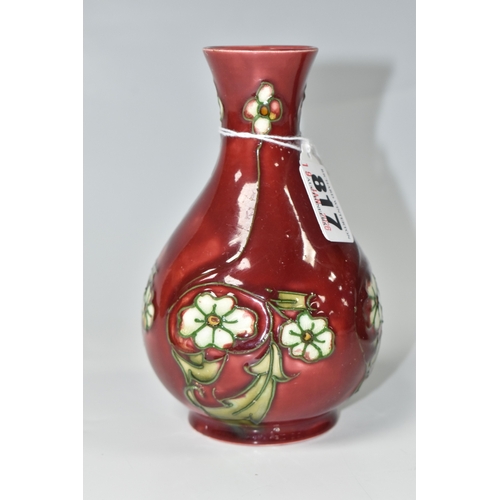 817 - A MINTON SECESSIONIST BALUSTER VASE, tube-lined with white flowers on a red ground, shape no 33, pri... 