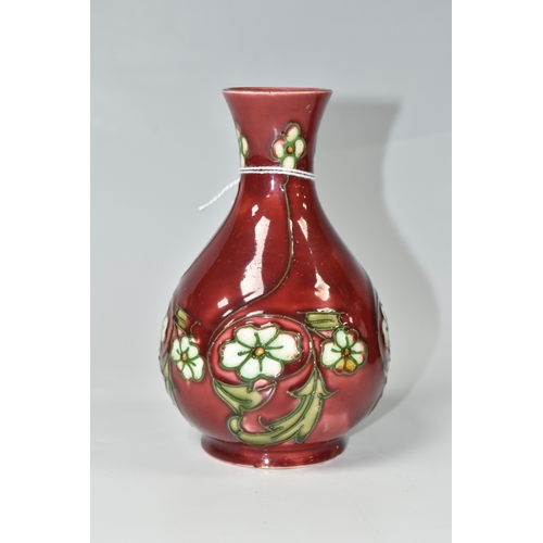 817 - A MINTON SECESSIONIST BALUSTER VASE, tube-lined with white flowers on a red ground, shape no 33, pri... 