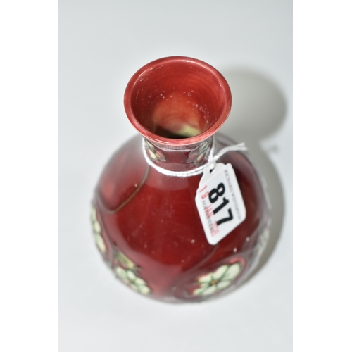 817 - A MINTON SECESSIONIST BALUSTER VASE, tube-lined with white flowers on a red ground, shape no 33, pri... 