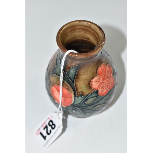 821 - A MOORCROFT POTTERY BALUSTER VASE, tube-lined with red flowers and forest green leaves on a brown gr... 