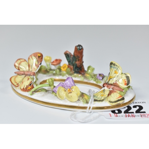 822 - A LATE NINETEENTH STEVENSON AND HANCOCK MENU CARD HOLDER, modelled with flowers and butterflies, pai... 