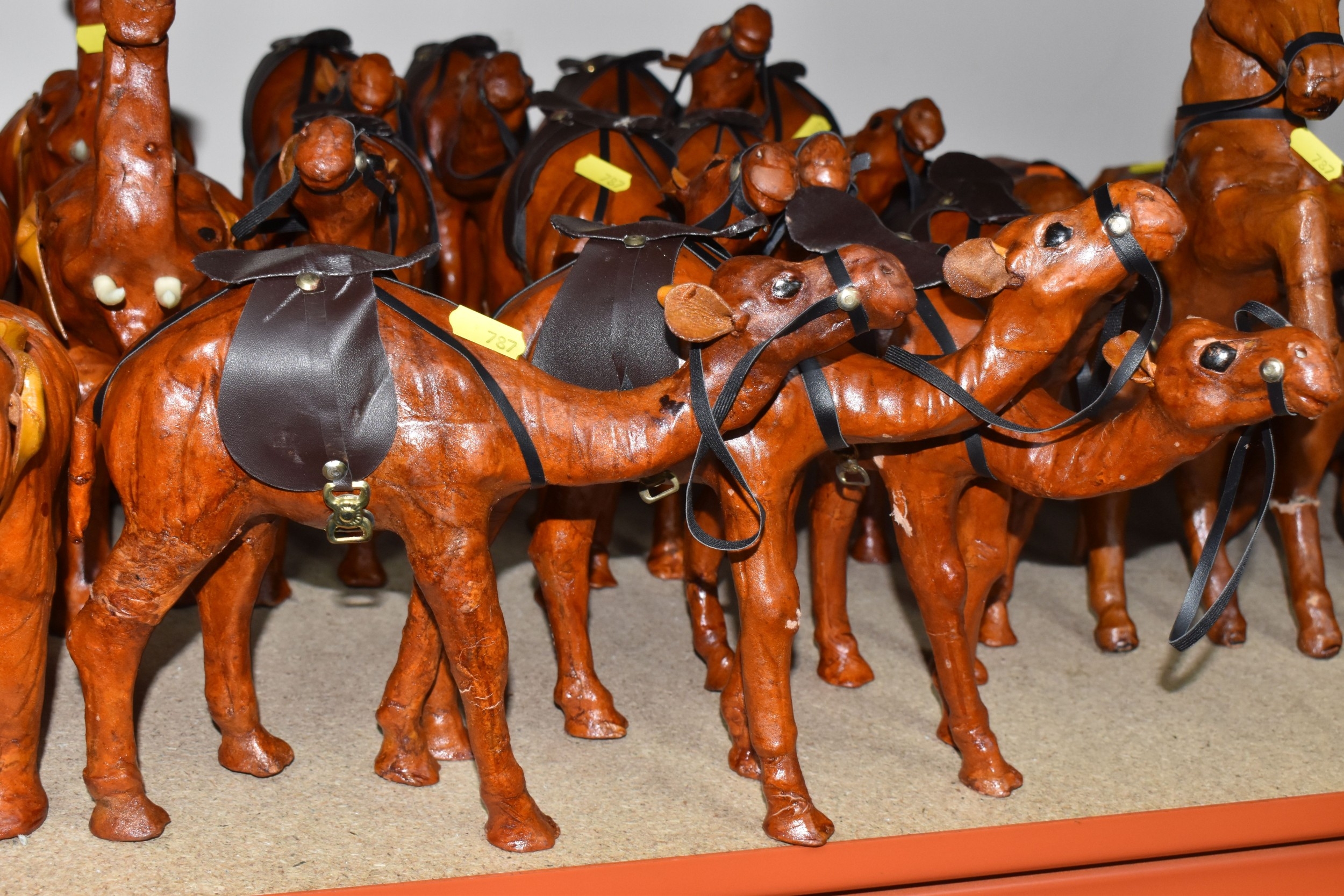 A COLLECTION OF LEATHER CAMELS, ELEPHANTS, AND HORSES comprising eleven ...