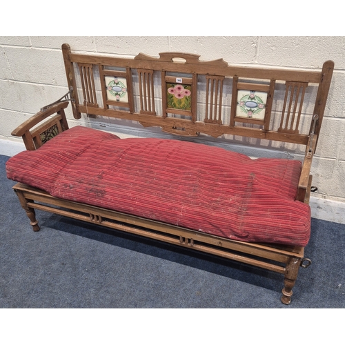 305 - AN ANGLO INDIAN TEAK BENCH, with a railway-style swinging back rest, inlaid with various tiles, rais... 